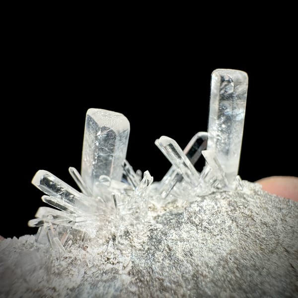 Long transparent aurora calcite prisms on grey rock from Zhejiang, China, reverse side