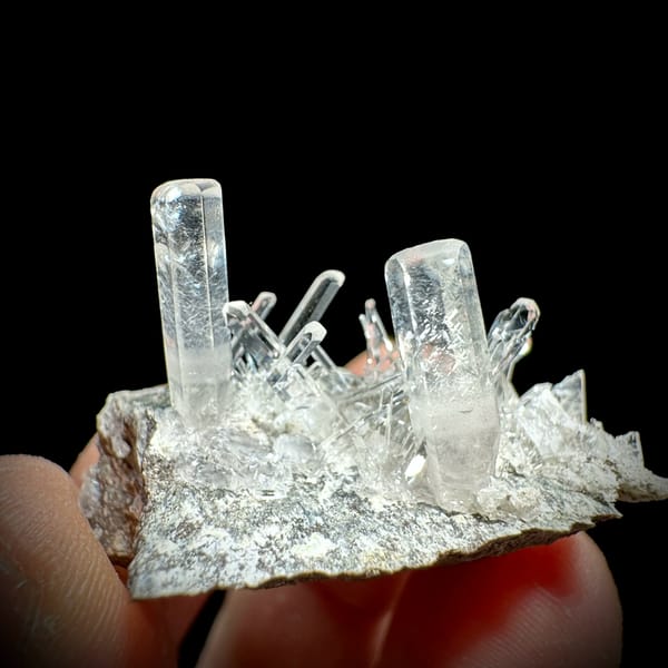Long transparent aurora calcite prisms on grey rock from Zhejiang, China, top view