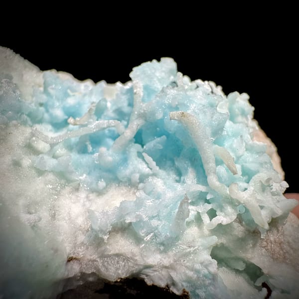 Sky-blue stalactitic aragonite in white aragonite frame from Yunnan, China, close-up of the crystal faces