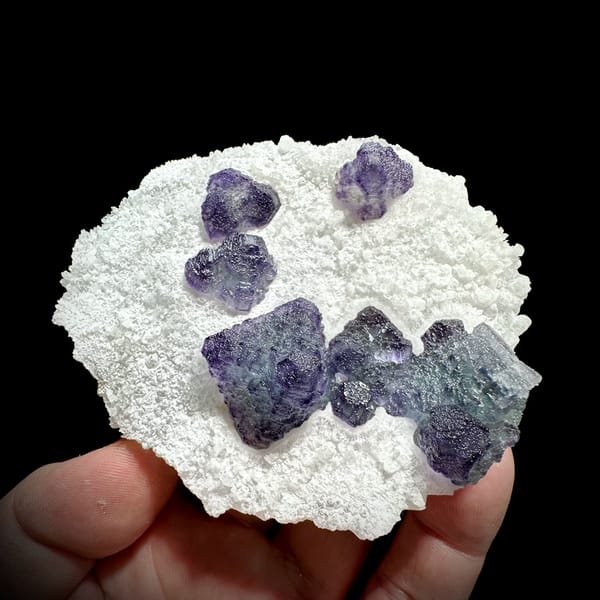 Frosted purple fluorite cubes on white sugar-quartz plate from Zhejiang, China, top view