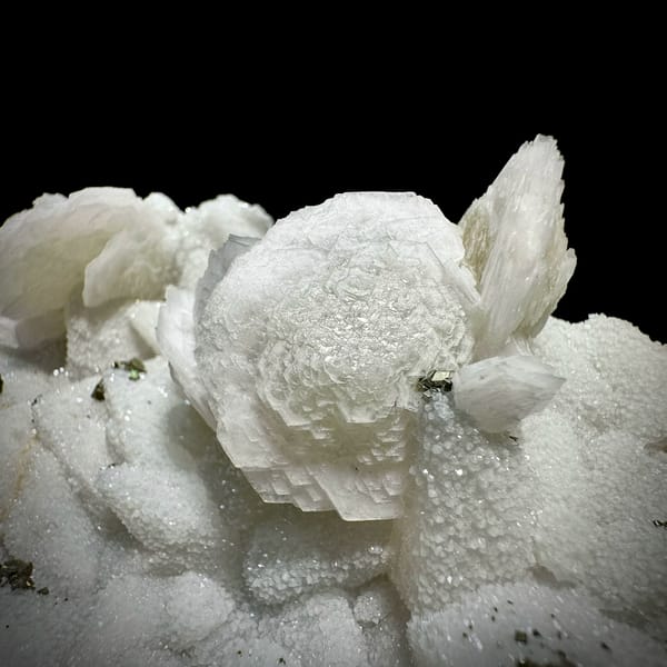 Plate of frosted white calcite crystals with pyrite from Fujian, China, close-up of the crystal faces