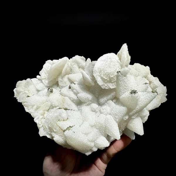 Plate of frosted white calcite crystals with pyrite from Fujian, China, detail of the matrix contact
