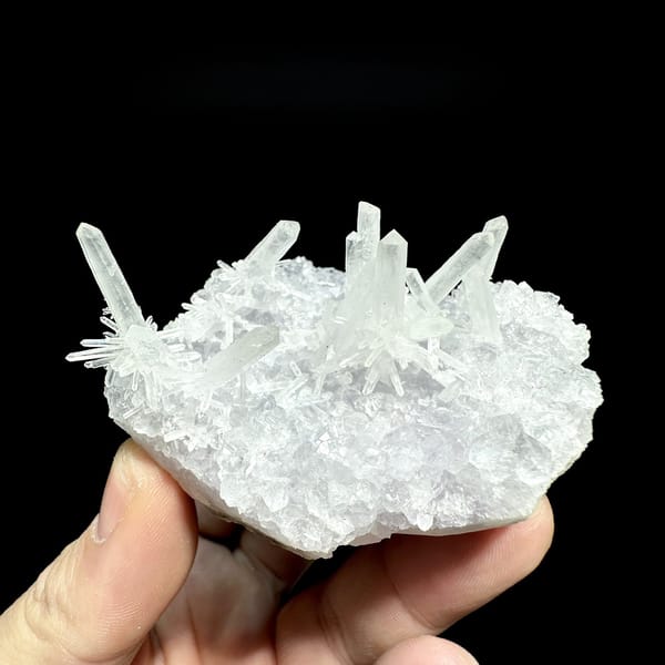 Fluorite base with spray of clear quartz needles from Fujian, China, detail of the matrix contact