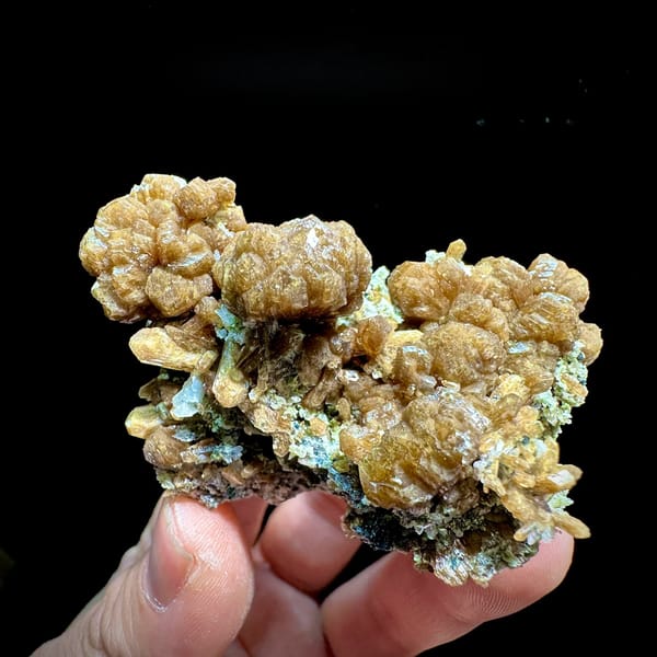 Golden-brown stilbite bow-ties with black specular hematite from Yunxiao, Fujian, China