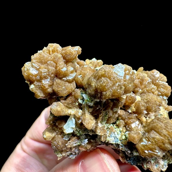 Golden-brown stilbite bow-ties with black specular hematite from Yunxiao, Fujian, China, reverse side
