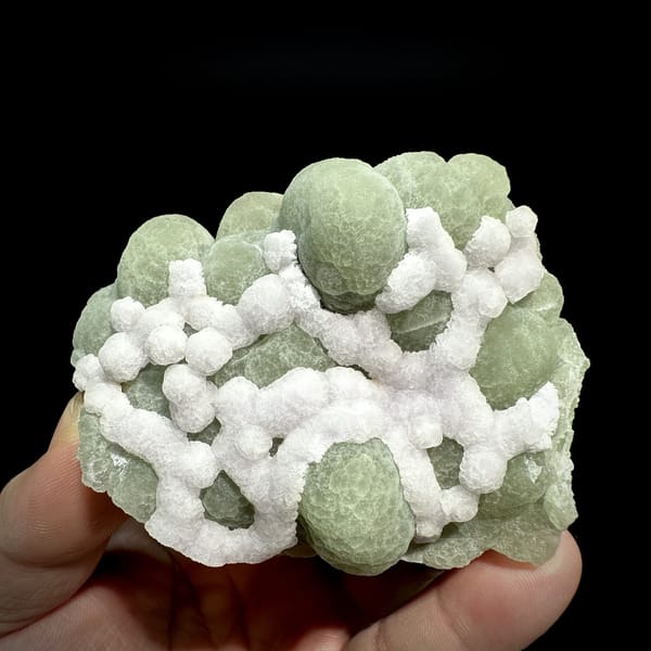 Mint-green fluorite balls laced with white fluorite from Henan, China, detail of the matrix contact