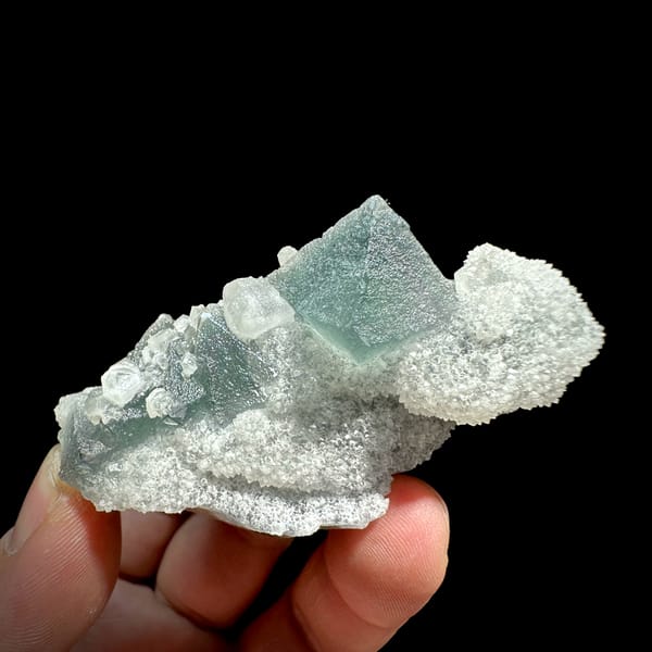 Green fluorite octahedron and hexagonal calcite on white quartz from Fujian, China, reverse side