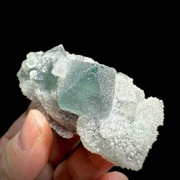 Green fluorite octahedron and hexagonal calcite on white quartz from Fujian, China, top view