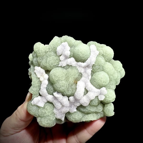 Pale green fluorite balls under lattice of white fluorite from Henan, China, detail of the matrix contact