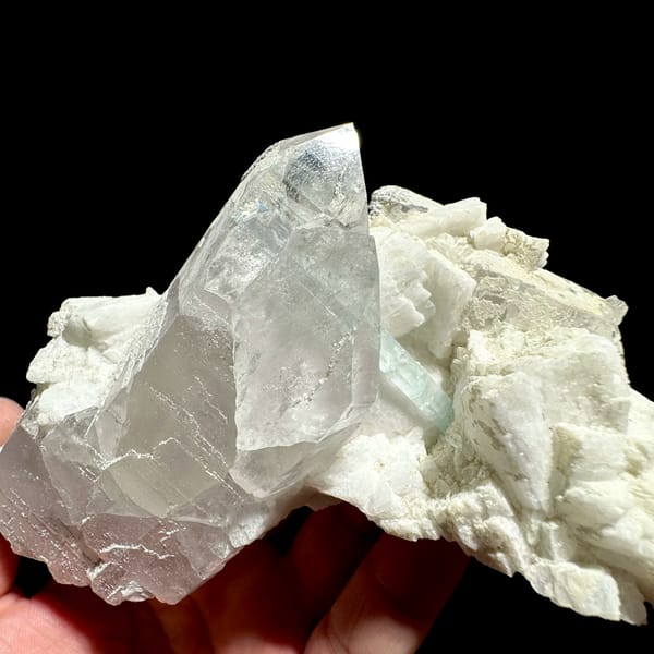 Pale aquamarine prism crossing clear quartz on feldspar from Pakistan, second angle