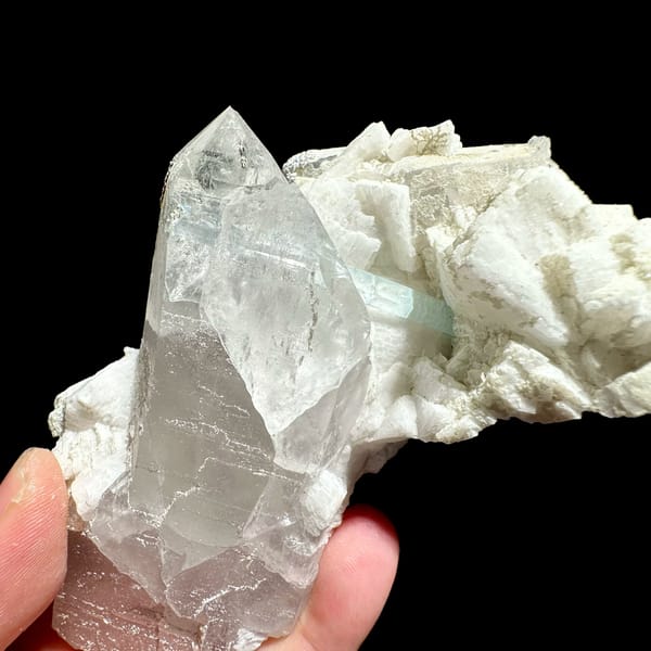 Pale aquamarine prism crossing clear quartz on feldspar from Pakistan, reverse side