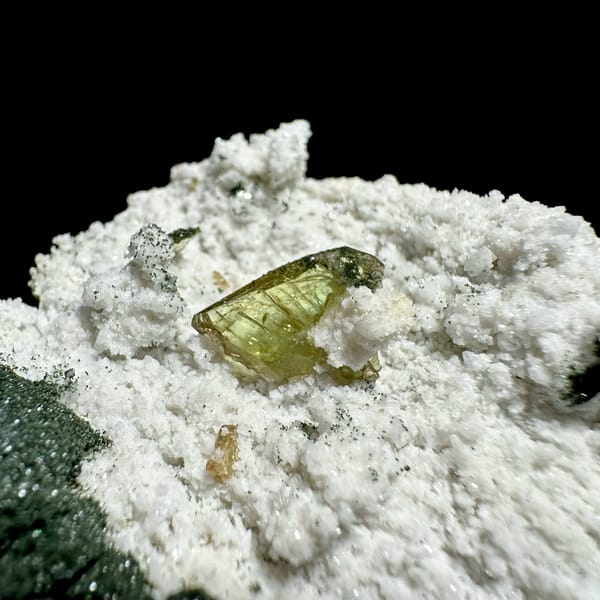 Yellow-green titanite crystal on white druse with chlorite from Pakistan, second angle