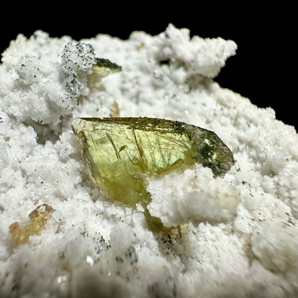 Yellow-green titanite crystal on white druse with chlorite from Pakistan, reverse side