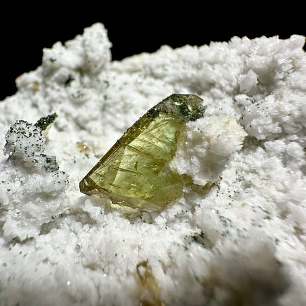 Yellow-green titanite crystal on white druse with chlorite from Pakistan, top view