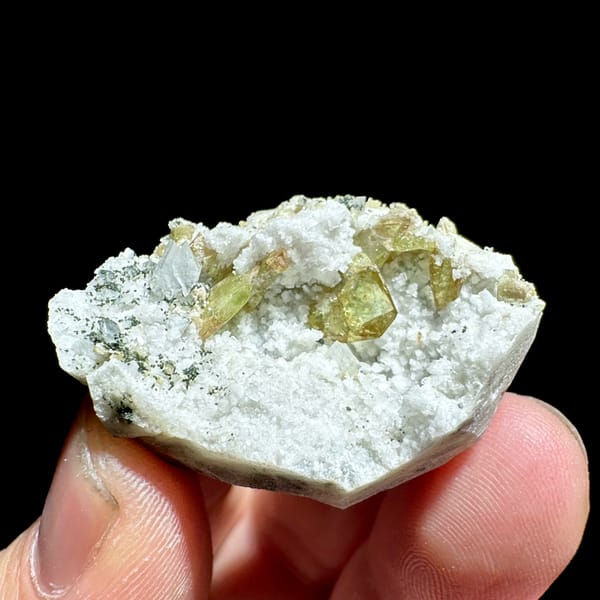 Yellow-green titanite crystals in white feldspar pocket from Pakistan, second angle