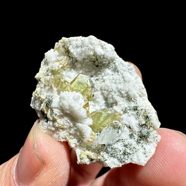 Yellow-green titanite crystals in white feldspar pocket from Pakistan, reverse side