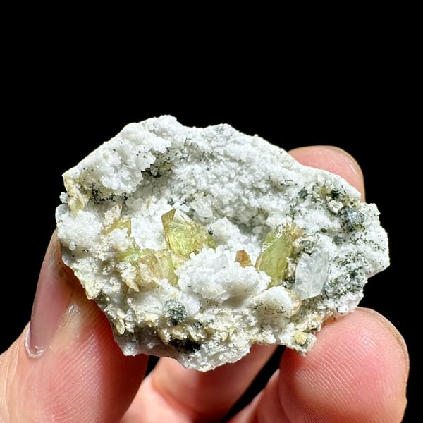 Yellow-green titanite crystals in white feldspar pocket from Pakistan, top view