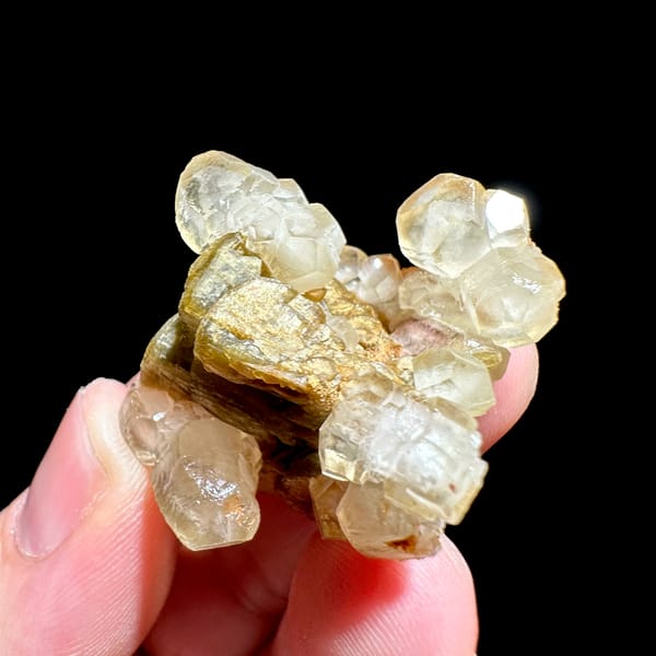 Translucent calcite rhombs around golden siderite from Guizhou, China, second angle