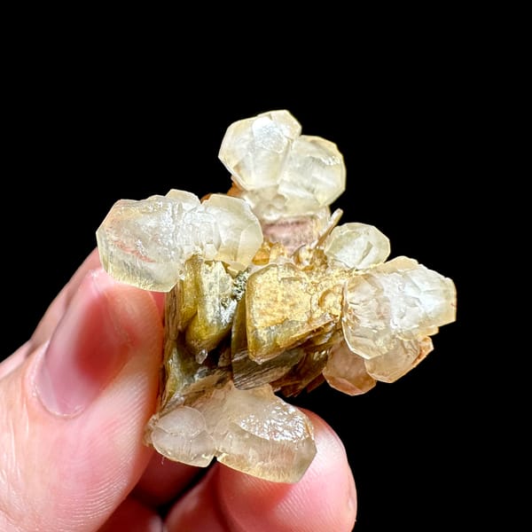 Translucent calcite rhombs around golden siderite from Guizhou, China, reverse side