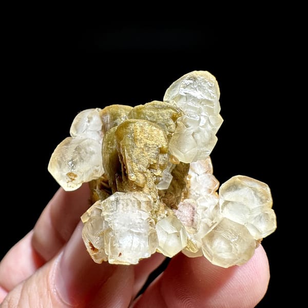 Translucent calcite rhombs around golden siderite from Guizhou, China, detail of the matrix contact