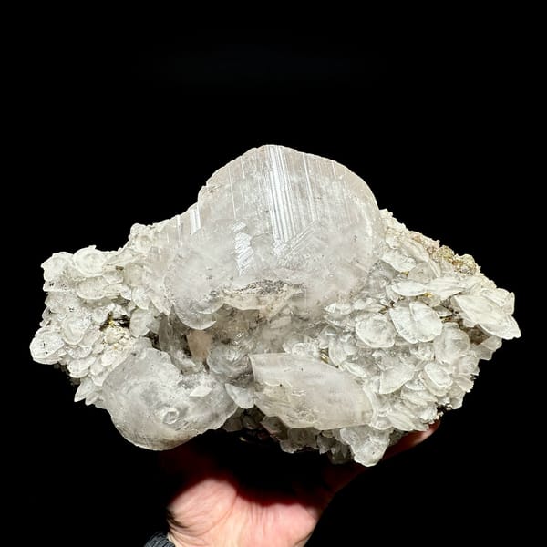 Large frosted calcite crystal over platy calcite and fluorite from Xianghualing, Hunan, China