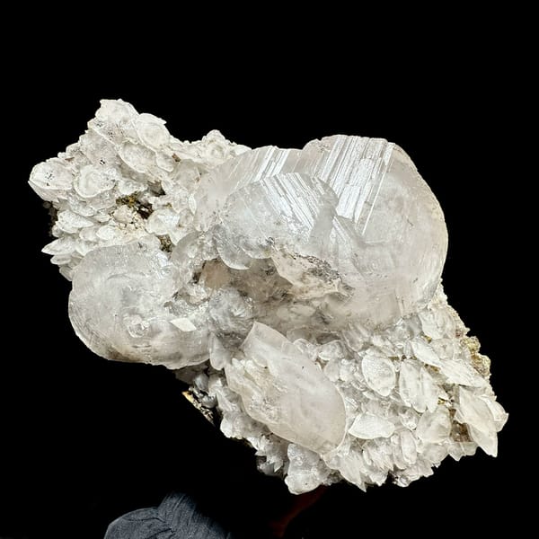 Large frosted calcite crystal over platy calcite and fluorite from Xianghualing, Hunan, China, close-up of the crystal faces