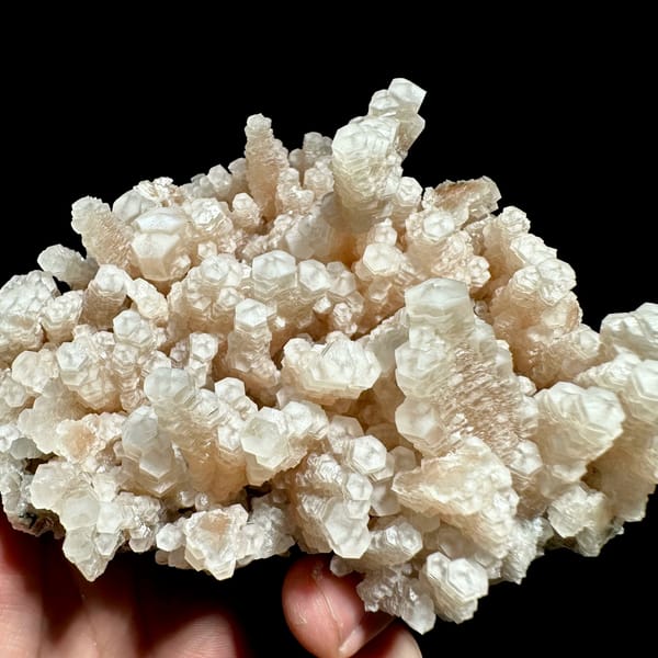 Coral-like spray of peach tower calcite from Fujian, China, close-up of the crystal faces