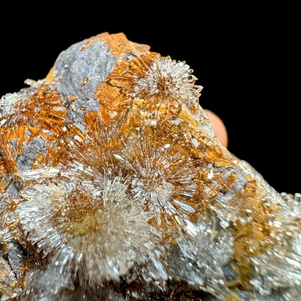 Transparent creedite flower sprays on rust-orange matrix from Guizhou, China, second angle
