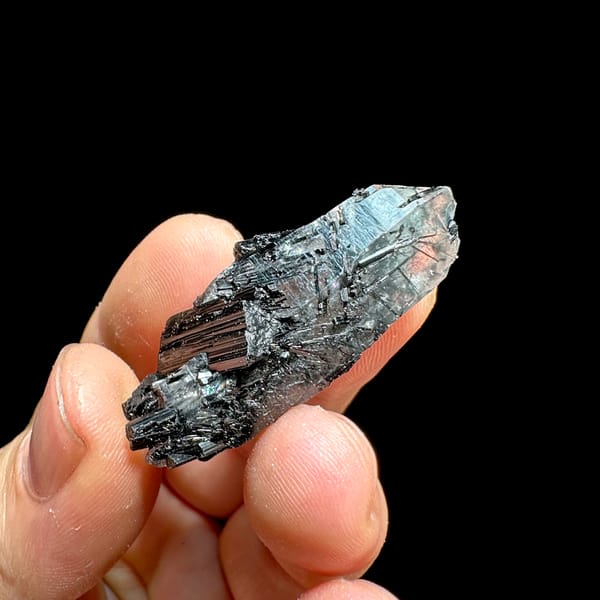 Clear quartz floater enclosing black tourmaline needles from Guangxi, China, close-up of the crystal faces