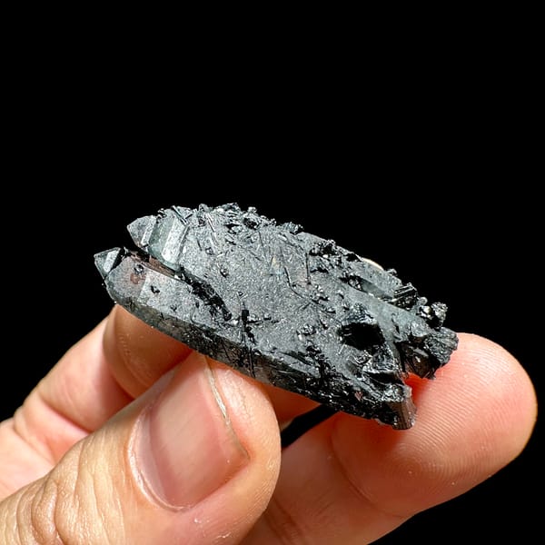Clear quartz floater enclosing black tourmaline needles from Guangxi, China, reverse side