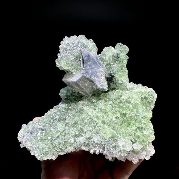 Large frosted calcite crystal on pale green fluorite and quartz from Fujian, China, detail of the matrix contact