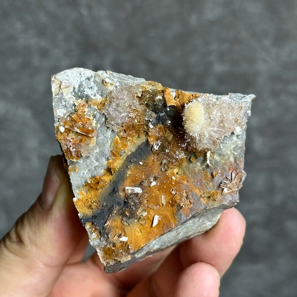 Sunflower creedite sprays on rust-and-grey matrix from Guizhou, China, close-up of the crystal faces
