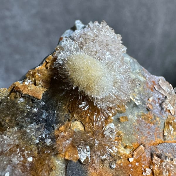 Sunflower creedite sprays on rust-and-grey matrix from Guizhou, China, top view