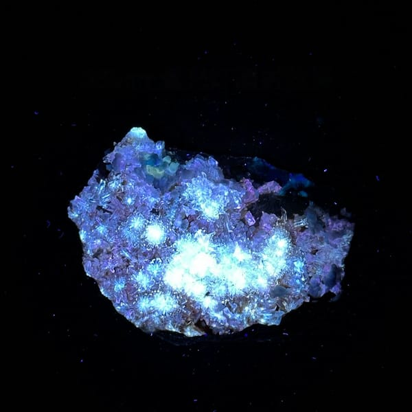 Creedite flowers over pale purple yttrofluorite from Guizhou, China, second angle