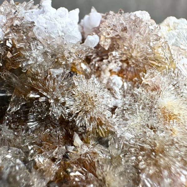 Creedite flowers over pale purple yttrofluorite from Guizhou, China, top view