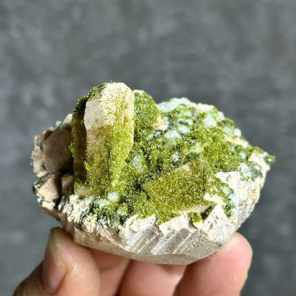 Lime-green epidote-coated feldspar prism on white base from Yunxiao, Fujian, China