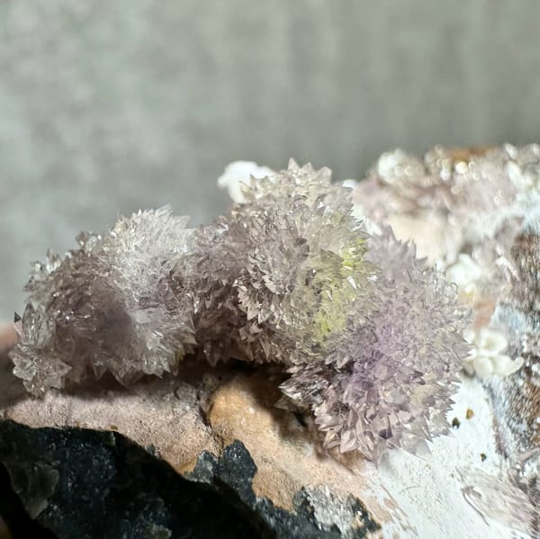 Purple and yellow creedite balls on grey matrix from Guizhou, China, reverse side