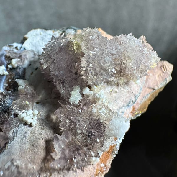Purple and yellow creedite balls on grey matrix from Guizhou, China, top view