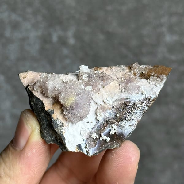 Purple and yellow creedite balls on grey matrix from Guizhou, China, detail of the matrix contact