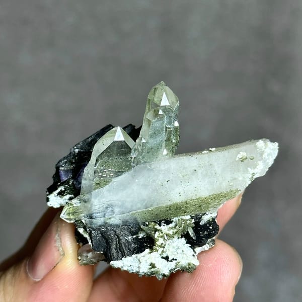 Clear quartz prisms with black wolframite and purple fluorite from Yaogangxian Mine, Hunan, China
