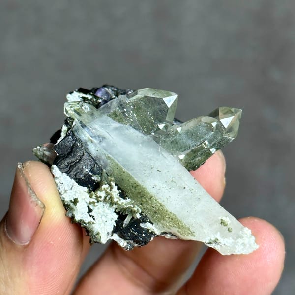 Clear quartz prisms with black wolframite and purple fluorite from Yaogangxian Mine, Hunan, close-up of the crystal faces