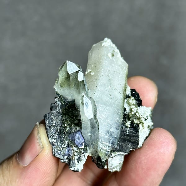 Clear quartz prisms with black wolframite and purple fluorite from Yaogangxian Mine, Hunan, China, top view
