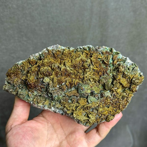 Iridescent pyrite crust covering calcite plate from Fujian, China, reverse side