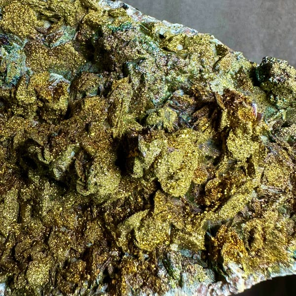 Iridescent pyrite crust covering calcite plate from Fujian, China, top view