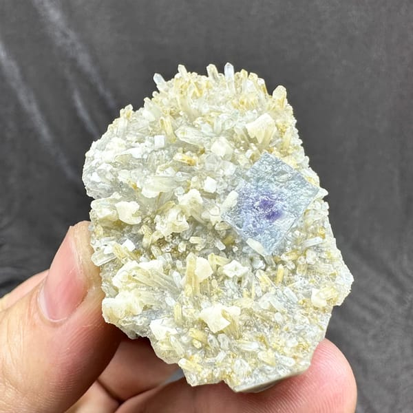 Pale blue fluorite cube on cream dolomite and quartz from Inner Mongolia, China, close-up of the crystal faces