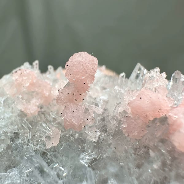 Band of pink rhodochrosite through white quartz needles from Guangxi, China, second angle