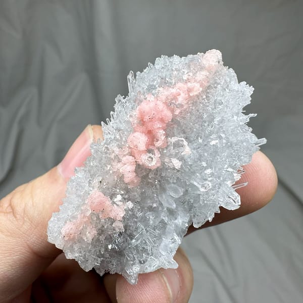 Band of pink rhodochrosite through white quartz needles from Guangxi, China, reverse side