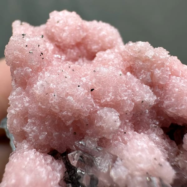 Rose-pink rhodochrosite over grey quartz with pyrite from Guangxi, China, top view