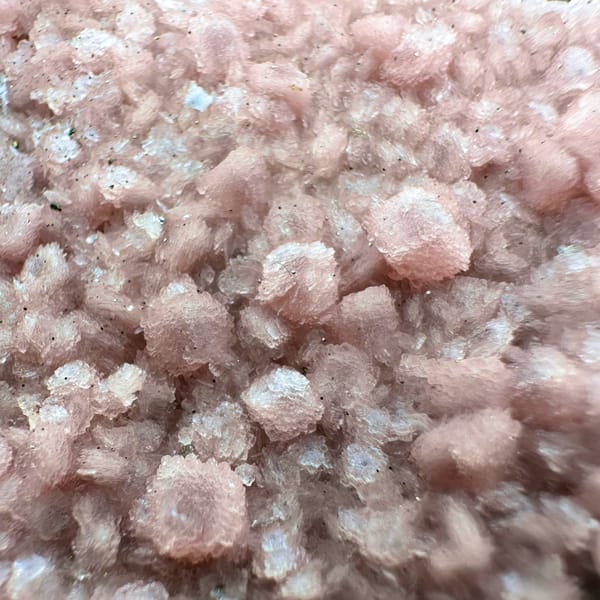 Pink rhodochrosite flecks in frosted white quartz cluster from Guangxi, China, second angle