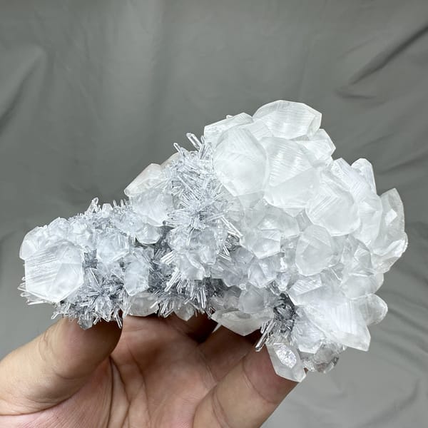 Floater of frosted quartz needles with calcite prisms from Fujian, China, detail of the matrix contact